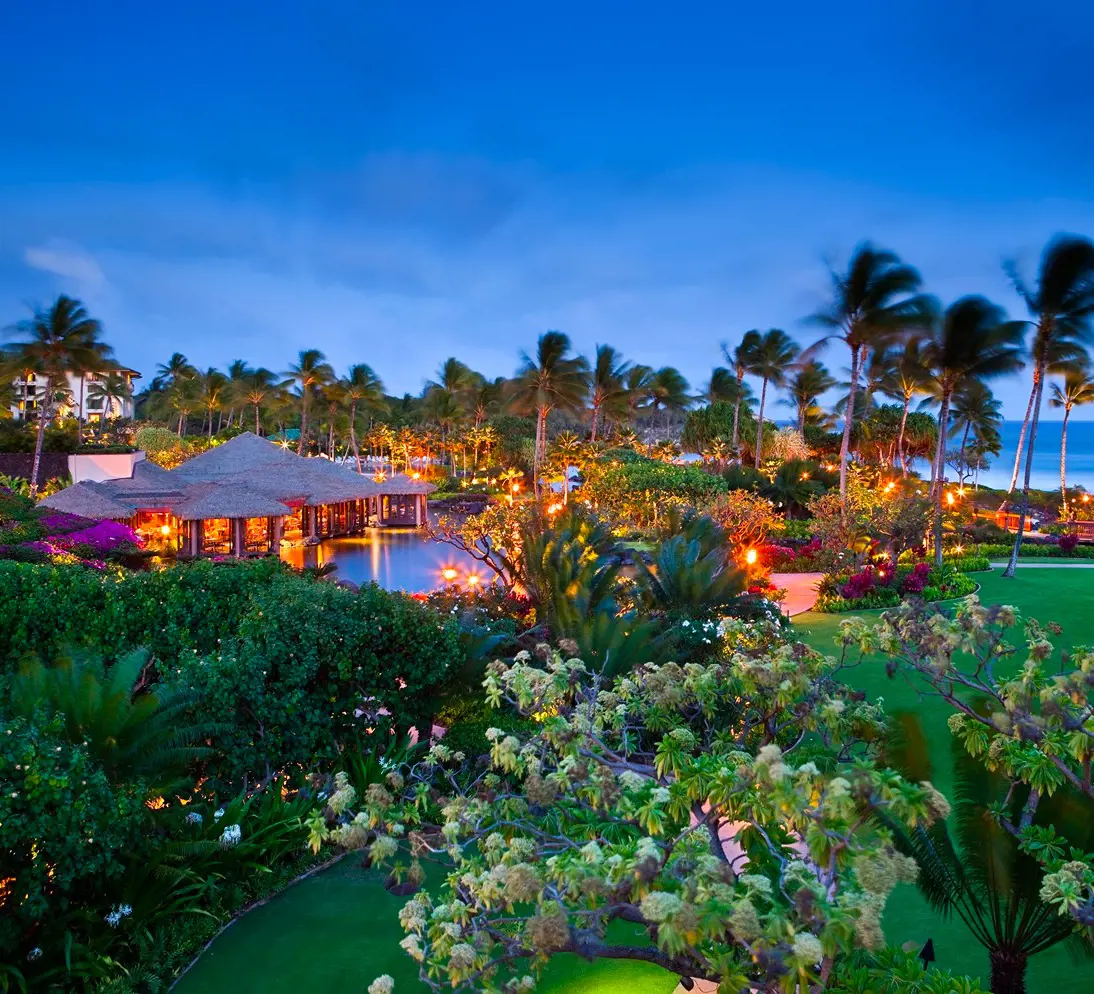 An eyecatching evening view of the poolside bar and lounges at Grand Hyatt Kauai Resort & Spa