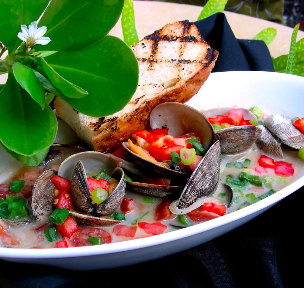Chef Keoni's steamed clams with fresh Waimea tomatoes and Portuguese sausage served at Napua at Mauna Lani Beach Club