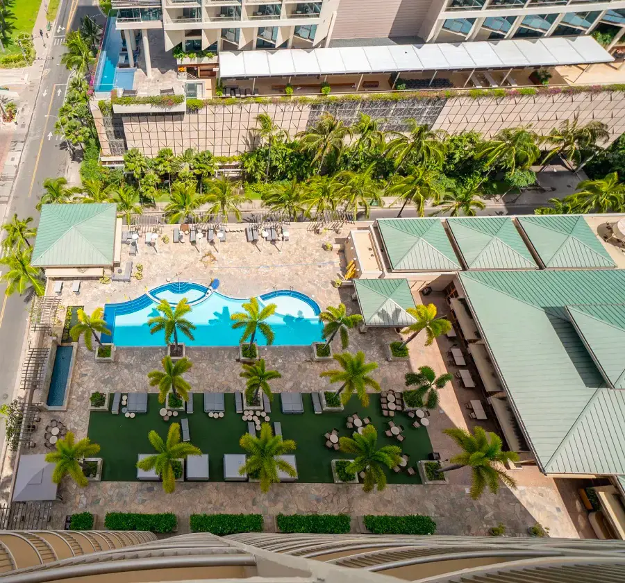 The outdoor pool and lounges at Embassy Suites Waikiki Beach Walk pictured from the terrace
