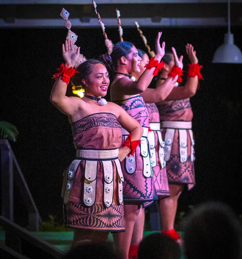 Artists beautifully dressed in traditional Hawaiian attire perform at Toa Luau