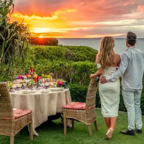 A couple enjoy a romantic sunset dinner together in Wailea