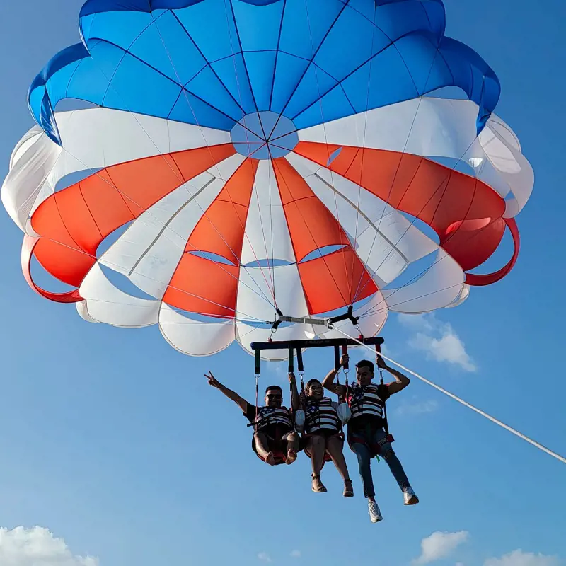 Third Coast crew parasailing on a bright and sunny day