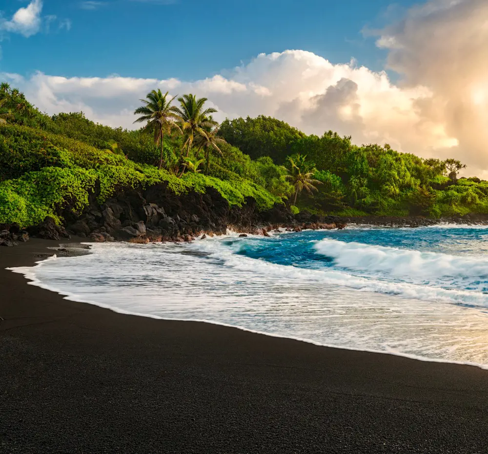 A scenic black sand beach in Hawaii gracefully captured by Matt Anderson