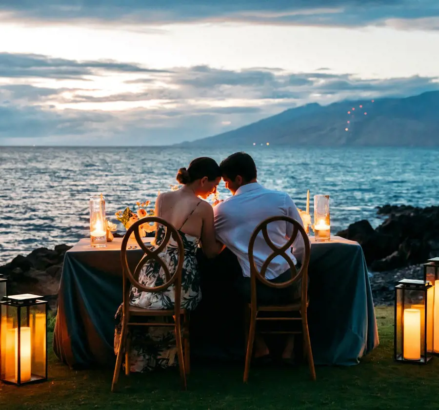 A couple enjoy a romantic sunset dinner at the ocean's edge at Wailea Beach Resort - Marriott, Maui