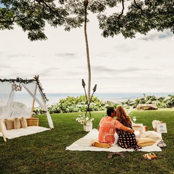 A couple enjoying a picnic at the garden of Holualoa Inn